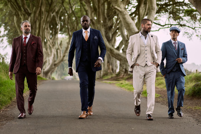 a group of men wearing latest collection of amen shoes uk and walking on a road