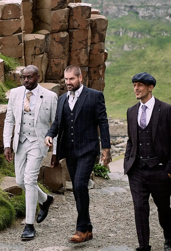 a group of men in suits wearing latest collection of amen shoes uk and walking on a path
