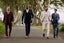 a group of men wearing latest collection of amen shoes uk and walking on a road